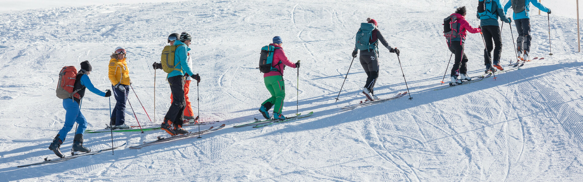 Group of ski tourers crossing the ski slope. 