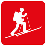 Red icon of a ski tourer.