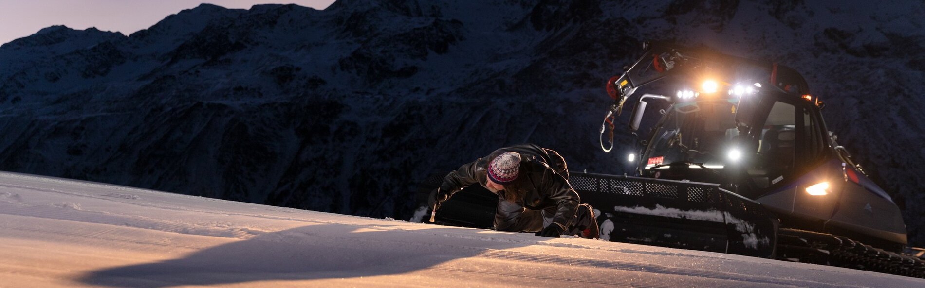 Snow groomer prepares the slope.