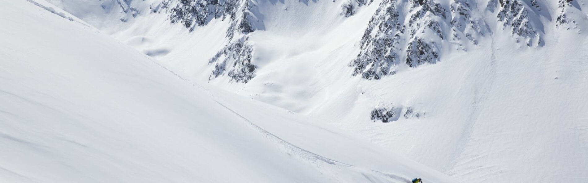 Schneebedeckte Berge mit Skifahrer