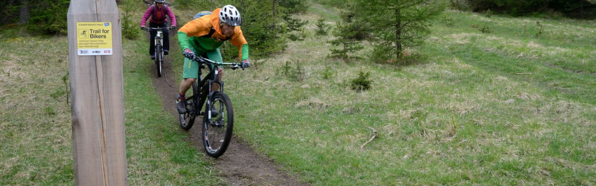 a mountain biker, single trail, single trail sign 