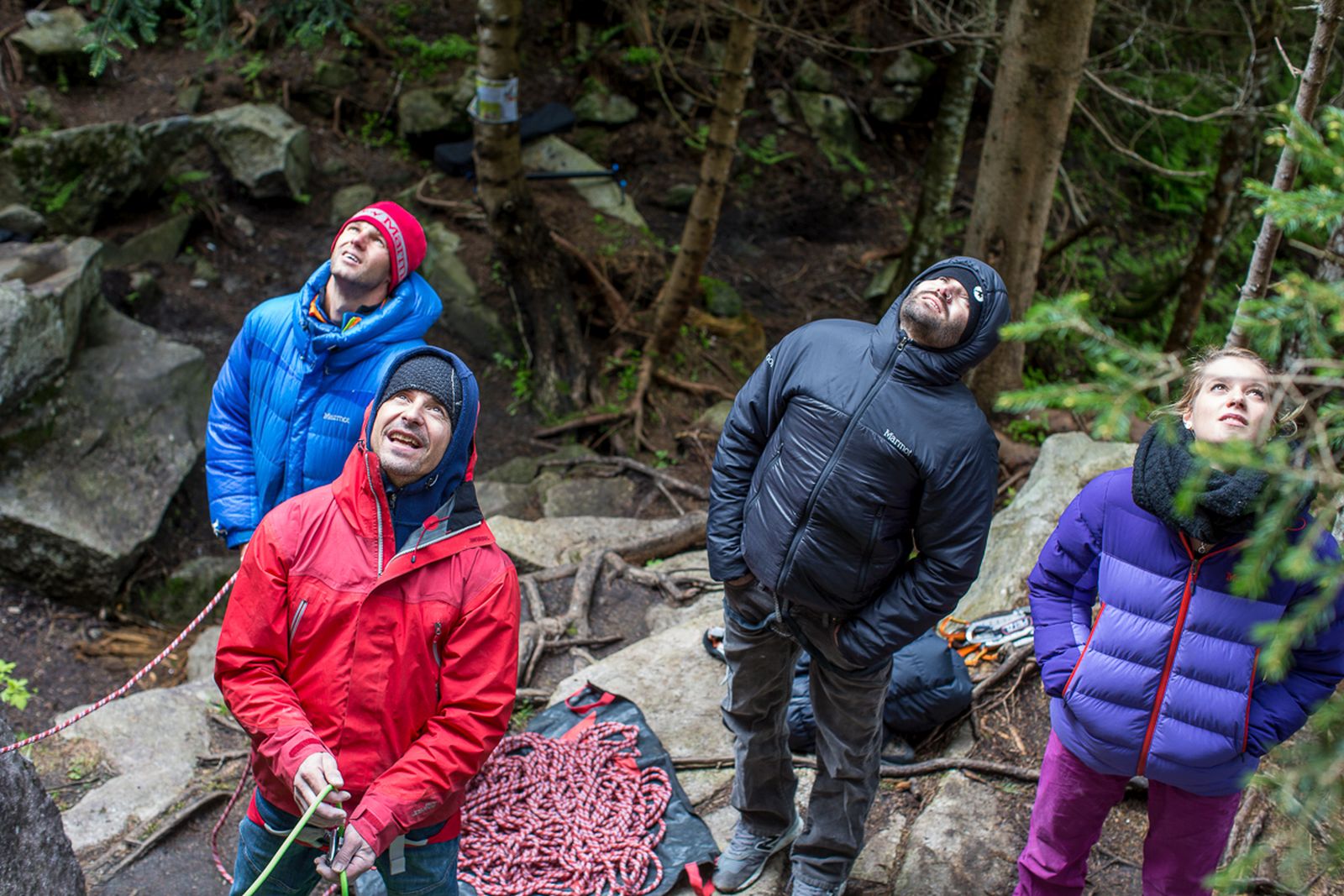 Four climbers look up.