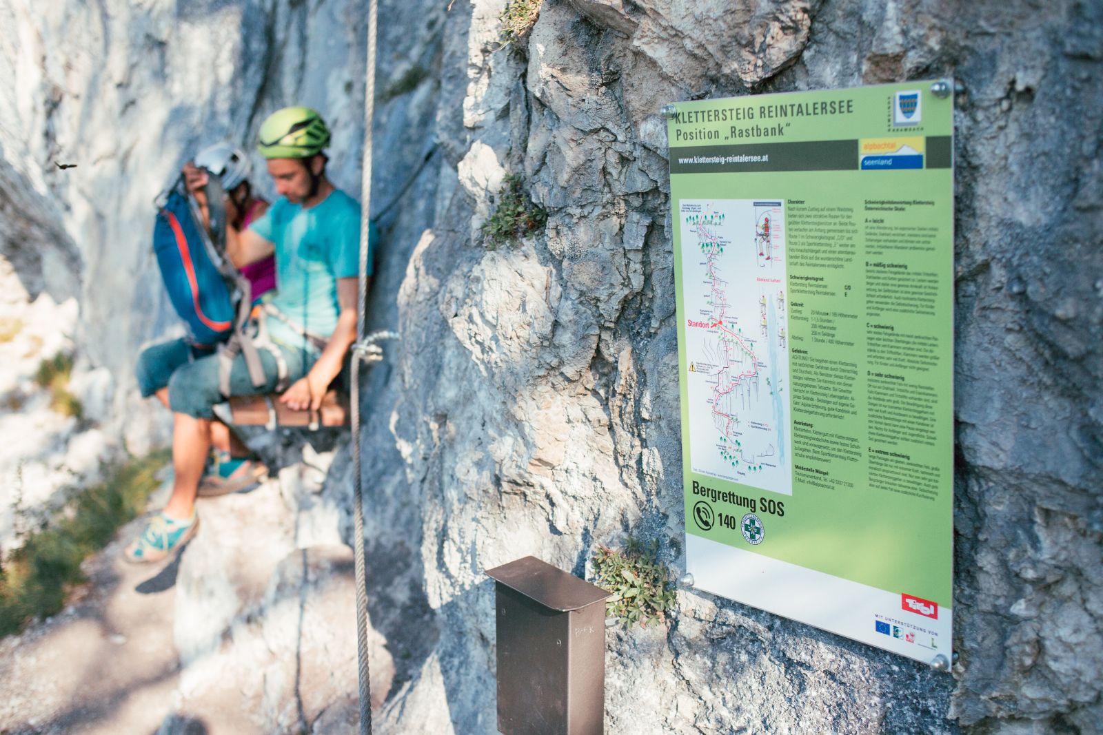 Via ferrata sign; 2 people at rest